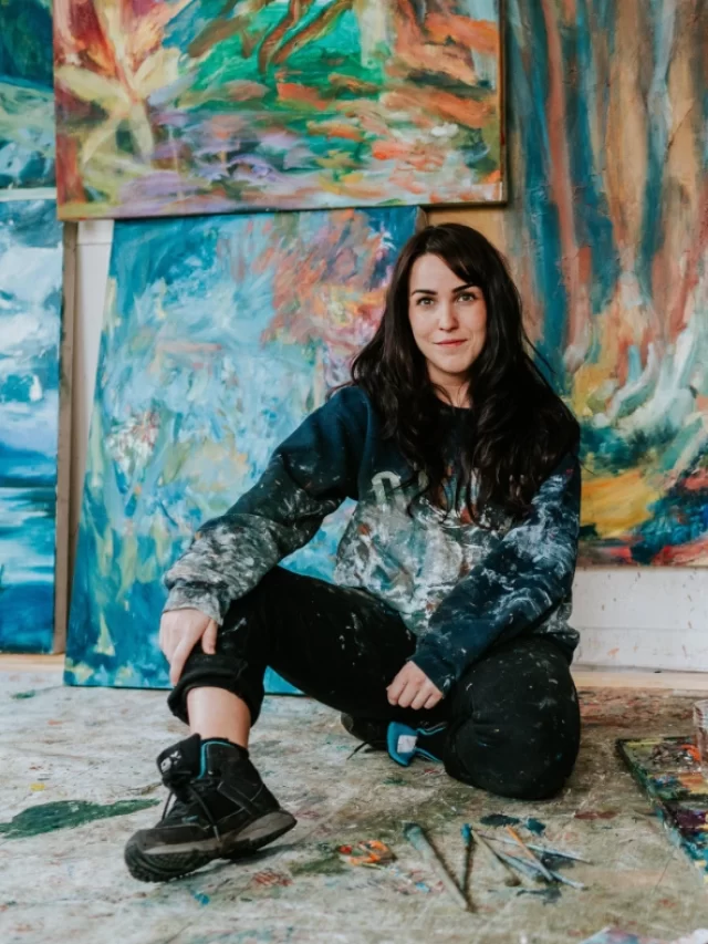 cropped-Sarah-Cunningham-Artist-sitting-infront-of-her-paintings-Courtesy-Cultured-Magazine.webp