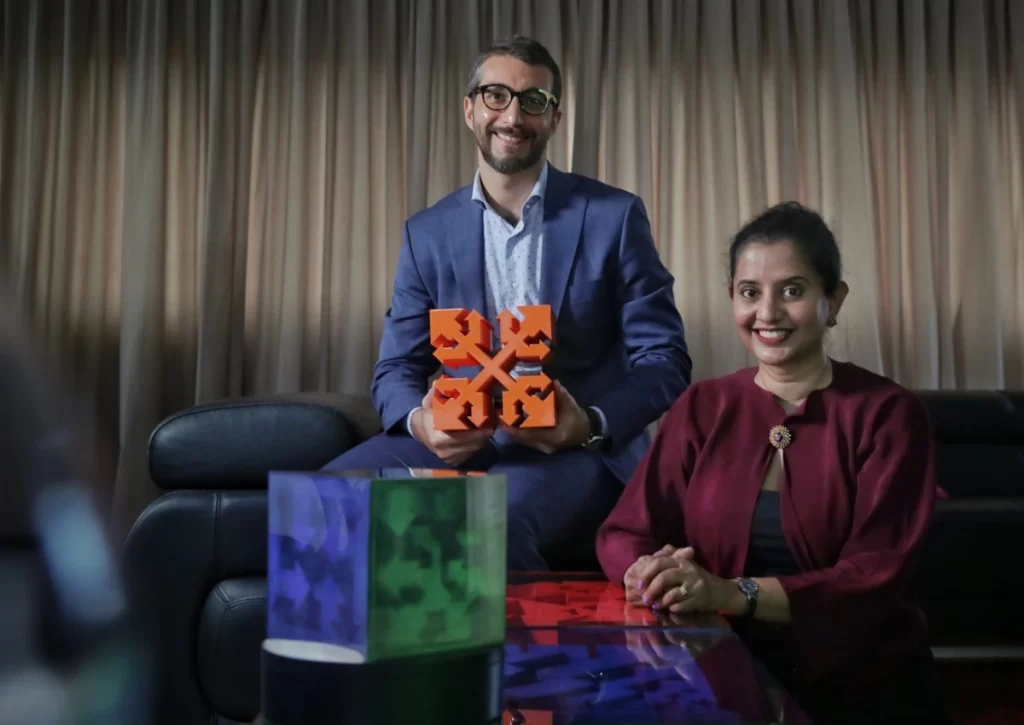 Assistant Professor Matteo Seita, who is holding the Cube of Interaction, and Ms Lakshmi Mohanbabu Artist