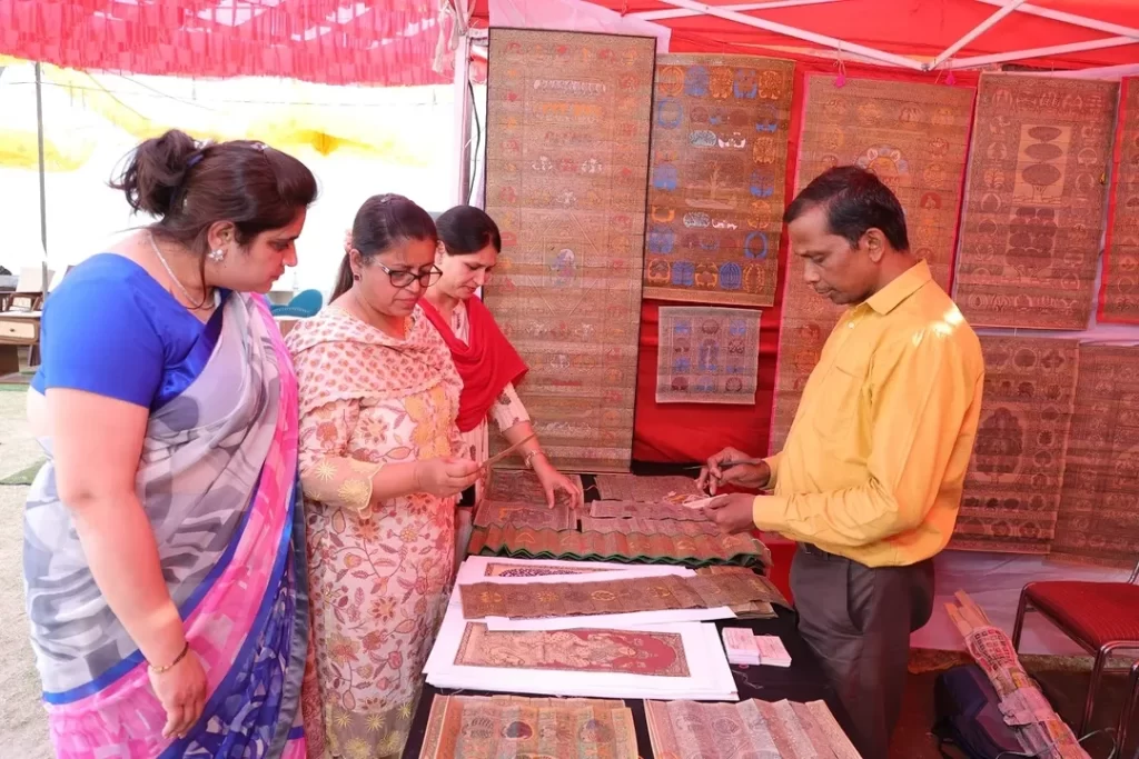 Buyers looking at paintings at Rajeshwari Kala Mahotsav