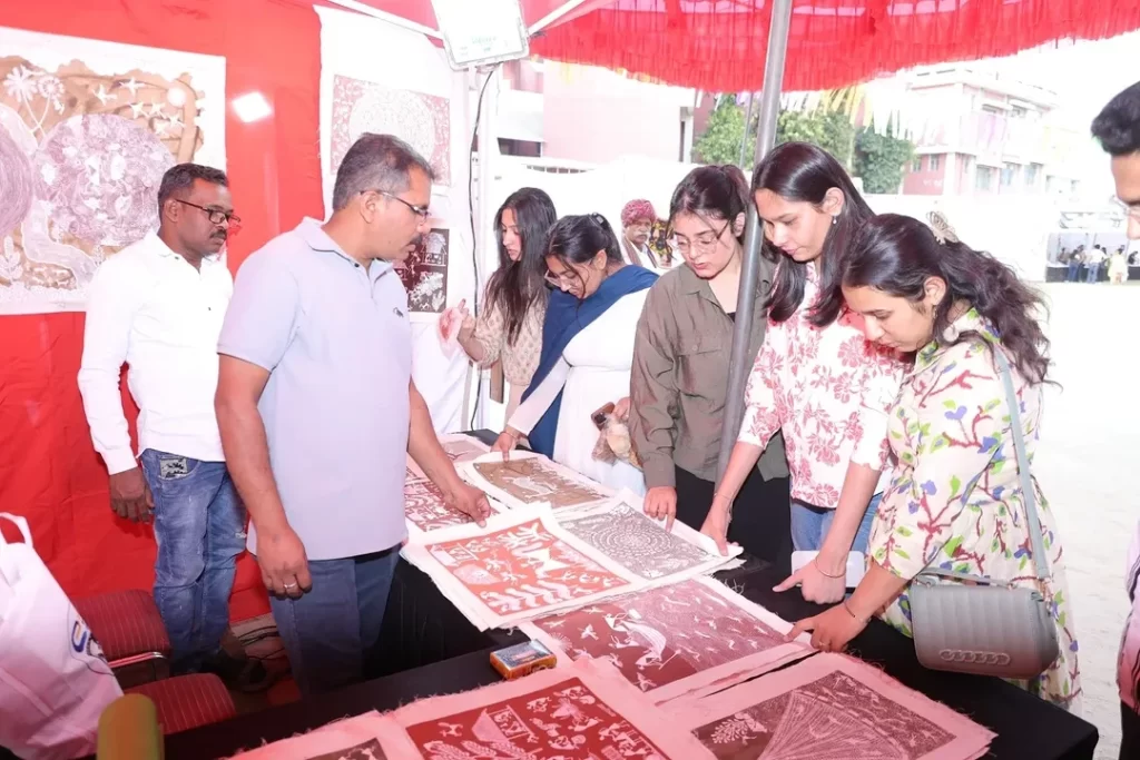 Looking at paintings in the mela at Rajeshwari Kala Mahotsav