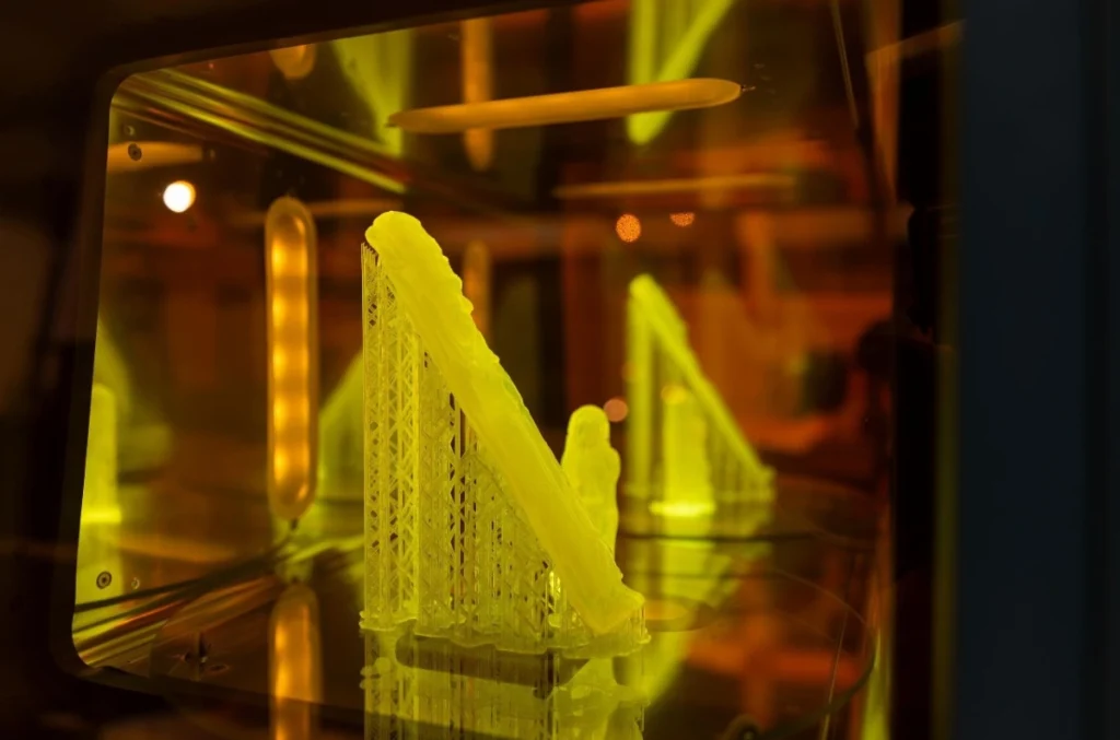 The 3D-printed resin figurines turn bright green in machines that help cure the material. Courtesy - Andrew Higley, UC Marketing + Brand
