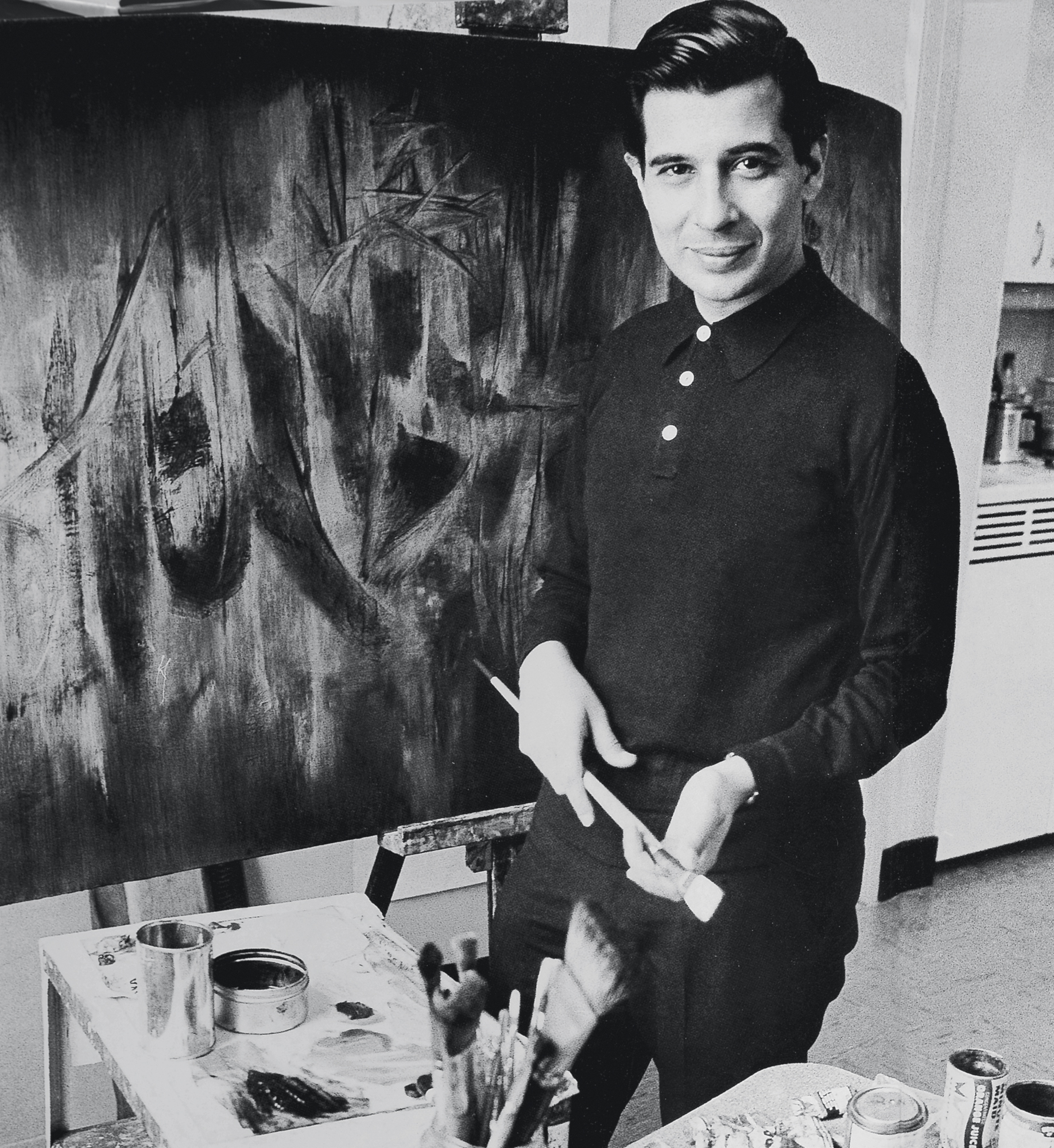 artist krishen khanna as a young man, holding a brush in this studio.