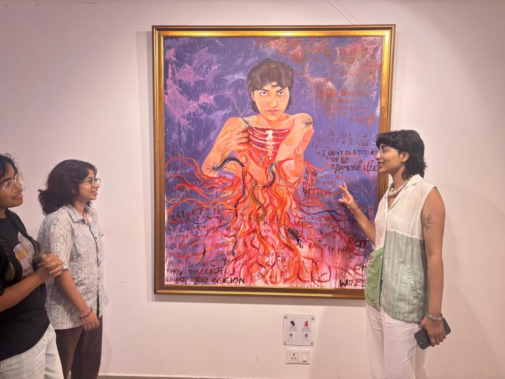 Khushi Khandelwal explaining her art to visitors