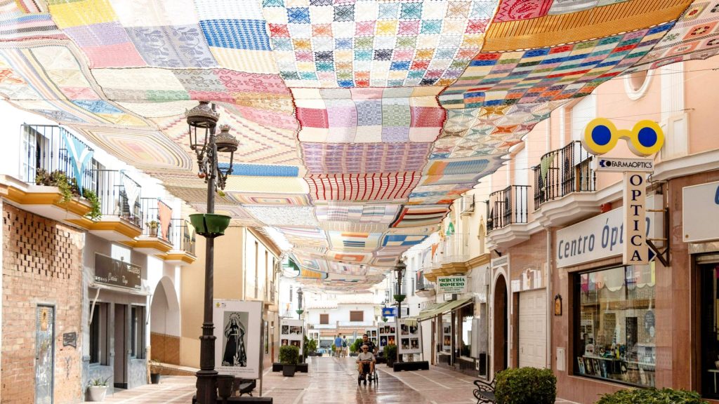 300 Women Turn a Spanish Street into a Summer Shade Sculpture